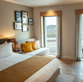 Image of double bedroom at Hilton Garden Inn with view over surf lagoon